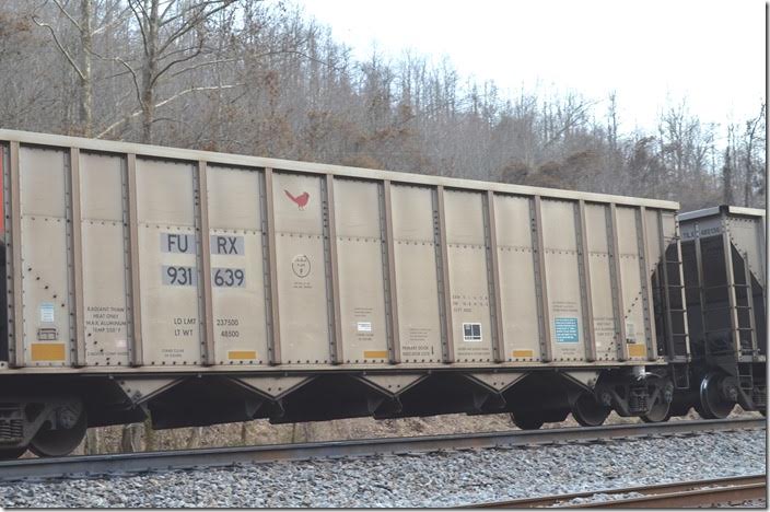 FURX (Wells Fargo Rail) hopper 931638 on w/b 757-17 (Belews Creek NC to Williamson-Big Omer Mine) at Devon WV. Note the red cardinal logo. This car is ex-DEEX 8670. Devon WV.