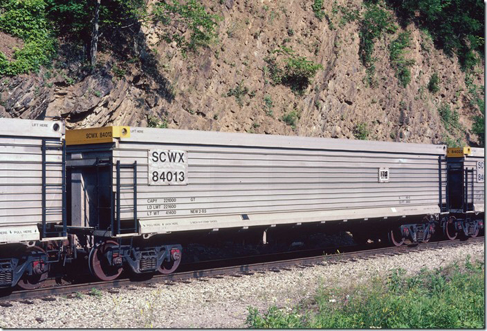 South Carolina Public Service Authority purchased enough of these gons from Portec Railcar Group (Winder GA) to equip a train. The cars were built in February and March 1985, had a load limit of 221,000 and a volume of 3,850 cubic feet. Seen here on the switchback at Smiley VA, on 06-09-1985, they were commonly seen on Santee-Cooper coal trains from former L&N and C&O lines in Eastern Kentucky. SCWX 84013.