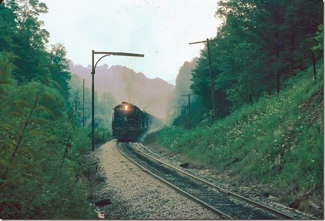C&O 6022 et al struggle up the steep grade to Gun Creek Tunnel with 65x out of Evanston. 07-30-1977. Note that 6022 was leading both of these trains although three years apart! Dawkins Middle Crk SD.
