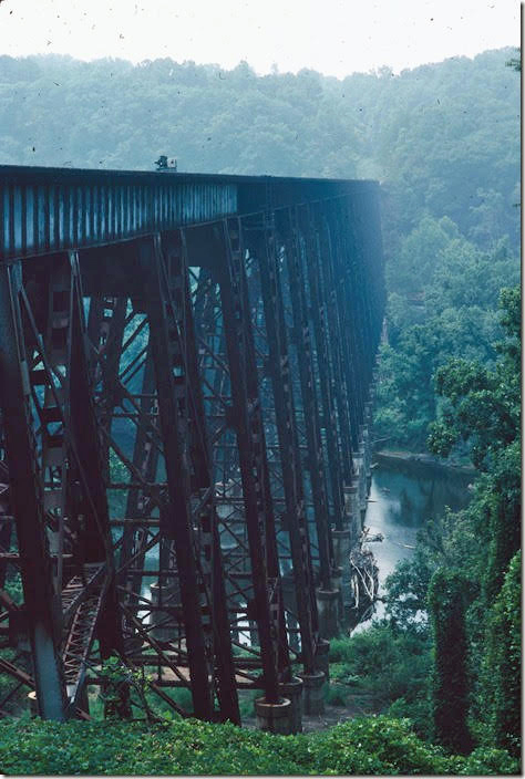 From the north side of Southern’s bridge, C&O e/b No. 92 heads toward downtown Lynchburg along the James River. 08-02-1987. James River SD.