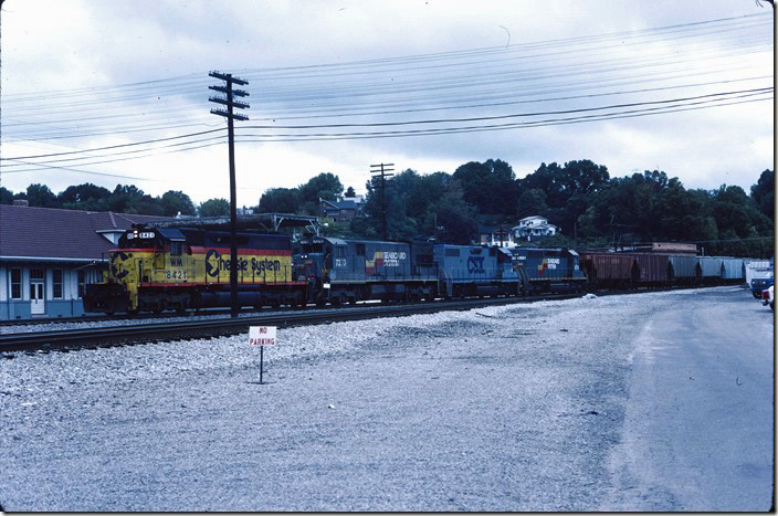 CSX, ex-WM, 8421 with 7270-2508-8179 bring southbound freight #549 into Corbin on 10-03-1987. The depot is on the left. It had been rebuilt in the 1940s with a second floor. Later a fire destroyed the addition, and it was converted back to a single story. By this time, however, the division office was located in the new building out of site on my right, and the old building served as a senior citizen center. Corbin KY.