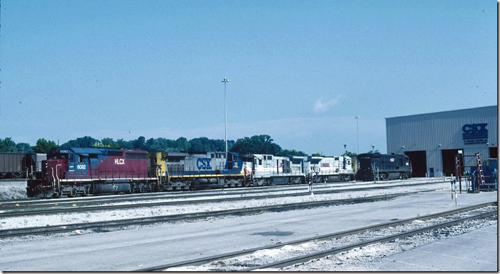 HLCX 6082, CSX 113, RLCX 8564-8561 and HLCX 6808 are parked at the south end of the diesel shop. Helm Leasing Corp. 6082 is ex-KCS SD40 610. Helm calls it a SD40M-3. 06-13-2004. CSX Corbin KY.