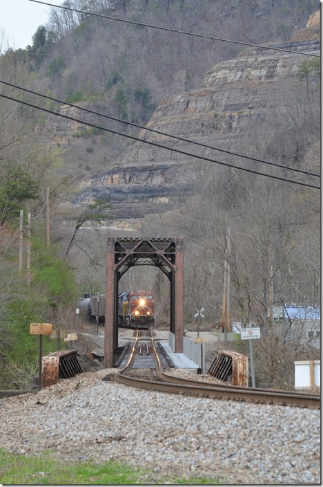 Approaching the Russell Fork bridge at Elkhorn City KY. The grade starts here. That’s new US 460 construction on the hill in the background. CP 8799-CSX16.
