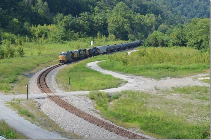 Ethanol train K440 e/b behind 5472-4538-40 have 76 cars on Aug. 27, 2017. This is the site of the Chaparral Coal prep. plant between Pikeville and Fords Branch. The train is approaching the beginning of double track at FO Cabin. A new road and bridge to the industrial site permits this easy shot. With the resumption of Duke Energy coal trains ethanol, grain, etc. trains are rare now. CSX 5472-4538-40. FO Cabin.
