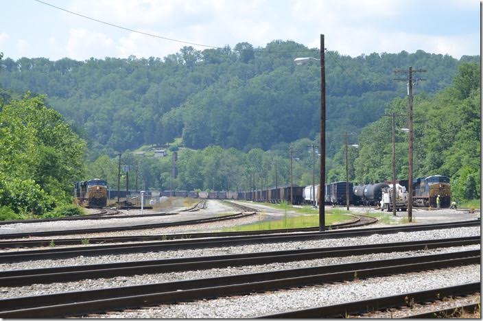 T051 pulls to the east end of the yard. The freight cars must be Q316 or Q317. CSX 719-720. Grafton WV