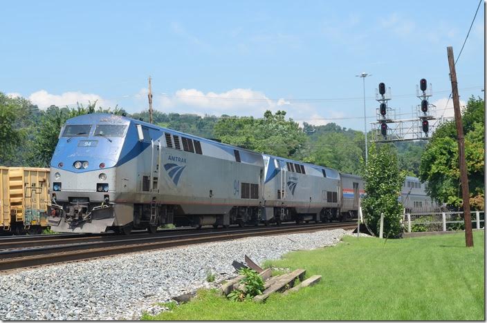 Amtrak P030, the eastbound Capitol Limited, departs at 11:55 AM (scheduled for 9:32 AM) with 9 cars behind Amtrak 94-132. Cumberland MD.