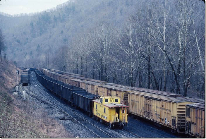 The e/b cantilever with the triangular configured lights have been replaced with standard color-light signal with a tall mast and a doll arm. Taplin was used at this time to store rolling stock or new AC&F “center flow” covered hoppers. C&O. Taplin WV.