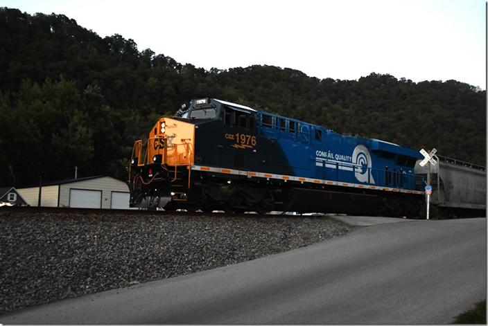 Late in the day on 09-19 and eastbound manifest came by with Conrail heritage unit 1976 serving as the DPU. I rushed up to a location just south of Pikeville KY once called Titan Siding. CSX 1976. CR Heritage.