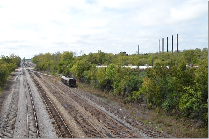 CSX 235-210 Ensley AL. Although the intermodal train was moving at the 10 MPH limit, we hustled ahead to Ensley to find a suitable photo location. The headlight is in the distance. On the right are all that remain of the once sprawling Ensley works of Tennessee Coal & Iron (USS). The mill closed in the 1980s. Birmingham Terminal’s yard and engine terminal are in the distance. 