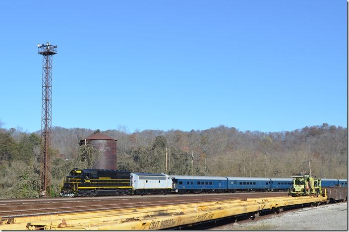 In mid-afternoon the Santa Train rolls into Shelby. That water tank and the flood light towers are the last steam-age structures left in Shelby. CRR 3632-800.