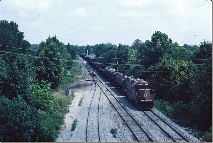 GP11 8737 switches the south end of the yard at Oaks TN. The Mayfield District veers off to the right of the distant signal mast. I shot this from the US 45E bypass which has little traffic. ICG Fulton 1986.