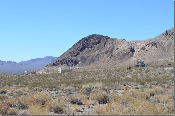 From the LV&T grade approaching Rhyolite from the east, we can see the ruins and depot. The grade continues up around the mountain past the two mining sites.