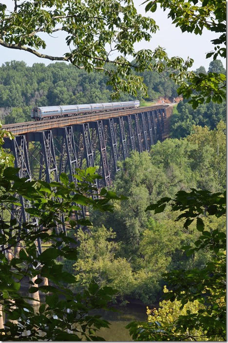 Amtrak Northeast Regional Train 156 (Roanoke – New York) speeds north on Sunday, 08-26-2018, with 8 cars behind engine 184 at 10:04 AM. Photographed from Riverside Park in Lynchburg. The C&O is just below us.