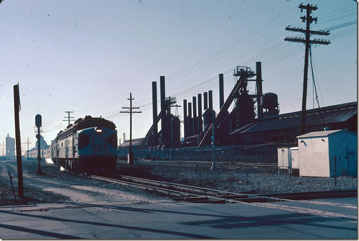 Heading north to Atlanta and eventually Washington, No. 2 passes the closed U. S. Pipe & Foundry blast furnaces at 32nd St. The former Sloss-Sheffield Steel & Iron landscape is now a city park and can be toured. By the way Sloss never took the process far enough to to produce steel – SSS&I and USP&F only produced iron for pipe, etc. Birmingham’s skyline is in the background. US 11 and L&N is on the other side of the mill. 01-29-1979.