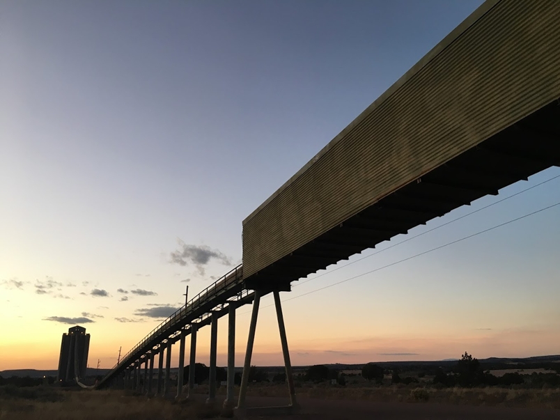 Conveyor belt line crossing the highway and railroad from the surface mine to the silo.