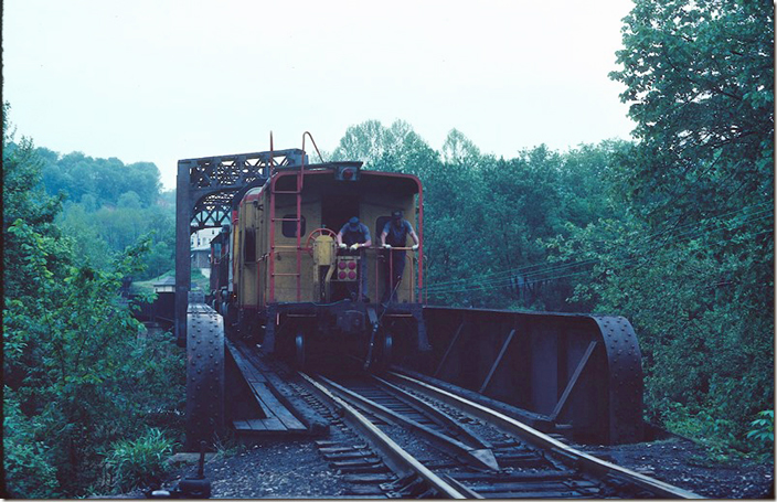 A shifter shoves his cab across the West Fork bridge from the M.R. (Monongahela River) SD on the other side.
