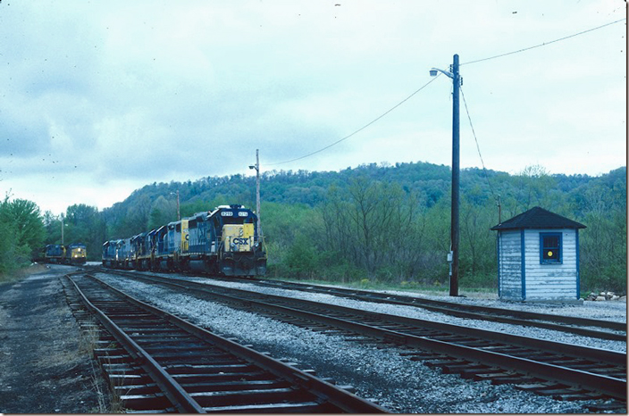 CSX 111-417 enter the south leg of the wye at Brooklyn Jct. (New Martinsville WV). Power for the several local freights that operate out of this terminal are parked on the right. 04-26-2004.