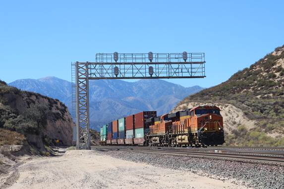 BN-SF 7197 and BN-SF 6614, both GE ES44C4, are seen east bound climbing up the hill for Summit.