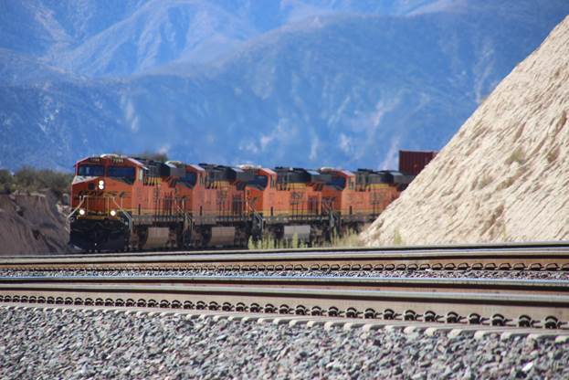 BN-SF 7298, BN-SF 7460, BN-SF 7577, and BN-SF 7252, all GE ES44DC locomotives, are fighting their way toward Summit with an eastbound 90 car stack train.