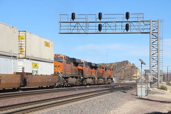 BN-SF 4496, a GE C44-9W; BN-SF 6673, a GE ES44C4; BN-SF 6601, a GE ES44C4; and BN-SF 8029, a GE ES44C4, are seen at Summit eastbound with a 110 car stack train.