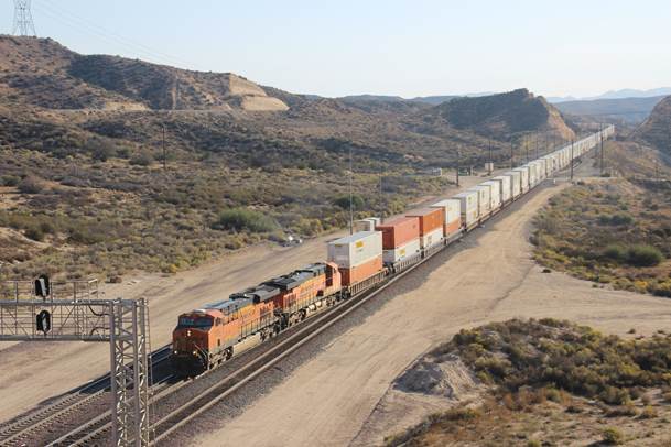 BN-SF 7380 and BN-SF 7547, both GE ES44AC units, having been given the “Highball” are on the move west.