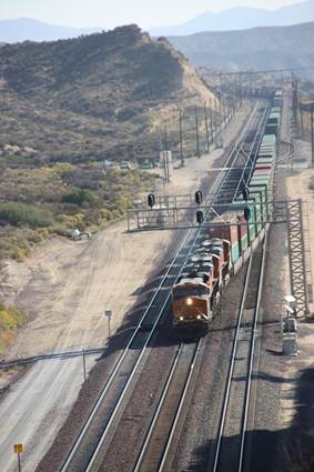 BN-SF 6720, BN-SF 6681, and BN-SF 6926, all GE ES44C4 locomotives, are seen westbound at Summit crossing from Track #3 to Track #2. 