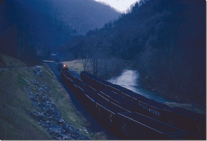 Extra 2309 arrives at Armco Steel’s new Sundial Mine at Edwight and starts switching at dusk. Big Coal, Cabin Creek SD.