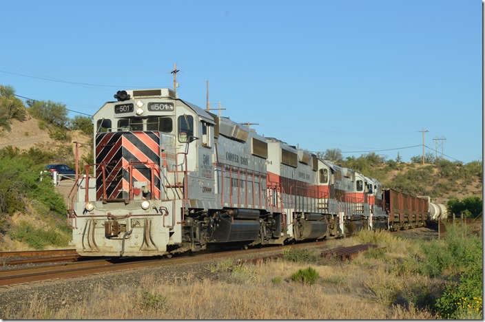 I rushed back to Ray Jct., for I knew the “Acid train” would be coming soon. OT-1 had given up the Ray block, so the “Acid Train” could come up to the mill. CBRY 501-304-402-504 have 13 cars. Ray Jct AZ.