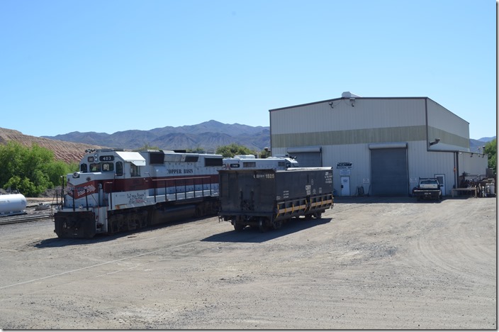 CBRY 403-208 parked on the east side of the locomotive/car shop at Hayden Jct. I signed a release at the dispatcher’s office which allowed me to shoot from the parking areas but not go any farther than this. No. 403 is an ex-Kennecott Copper GP39-2 that was inherited from the previous owner of the mine. ASARCO (American Smelting and Refining Co.) now owns the mine and the railroad. 208 is an ex-BN, nee-CB&Q GP9. Hayden Jct AZ.