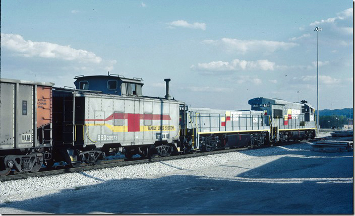 Former SCL cab 20973 and train is switched by MATE 5211-5785. Cabooses won’t be around much longer. 05-01-1988. L&N Corbin KY.