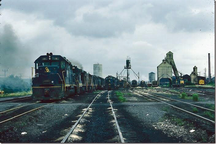 GP38 3892 awaits a call to take a train out of the center of the C&O. The variety of locomotive models is unimaginable today. That sand car on the far right catches my attention now. 06-25-1977. Russell '76-77.