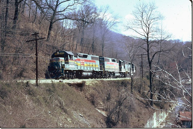 CRR 2005-2004-3615 struggle up the 1.8% between Dante and Sandy Ridge Tunnel. This short grade is the steepest northbound on the CRR main line. The Rex Turn will drop its 127 empties along the way down to below Haysi. 03-30-1982.