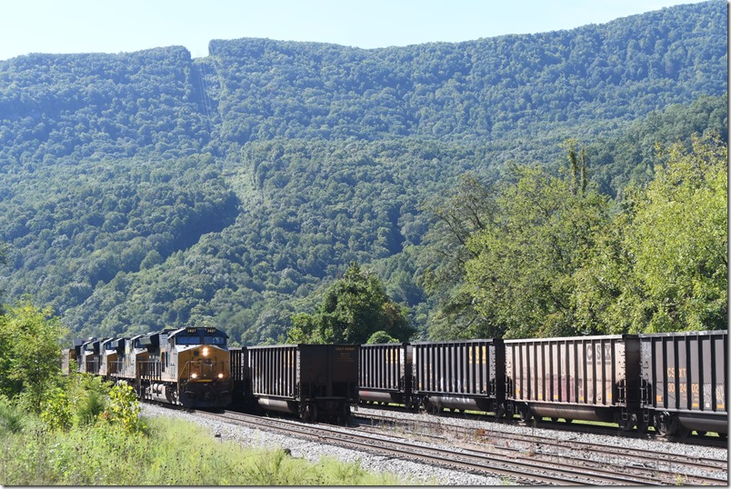 The McClure mine run pulls up the main at Elkhorn Yard (former CRR). Soon CSX 3427-5218-3462-254 show up with E312-01 which is 109 DKPX empties. He’s on the passing siding. The tubs are stored on the two yard tracks. That is Pine Mountain in the background. It is the state line with Virginia. 09-03-2024. Elkhorn City KY.