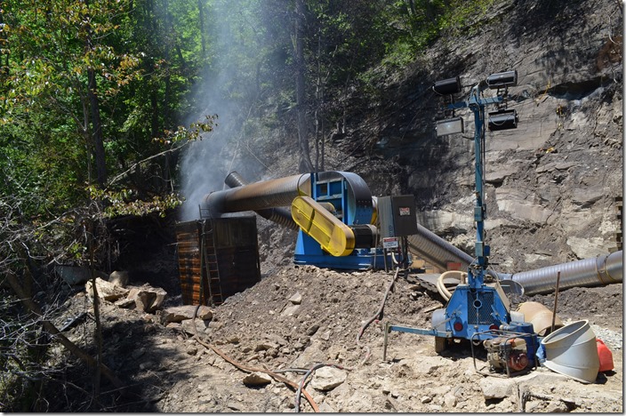 Contractors have this contraption for pulling and filtering air through the tunnel. That rust-colored thing contains water.