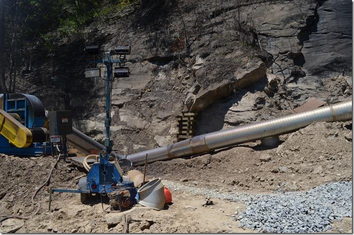 Contractors have this contraption for pulling and filtering air through the tunnel. That rust-colored thing contains water. View 2. 