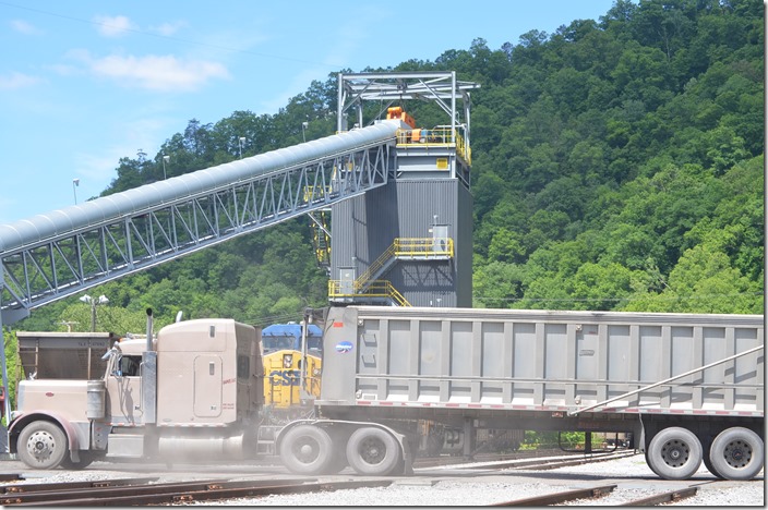 Coal trucks coming in left and right as the engines back past.