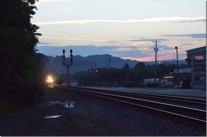 The headlight of CSX 7223-112-3333 flashes to bright, and this awaiting eastbound empty McClure Mine train starts pulling. WE Pauley.