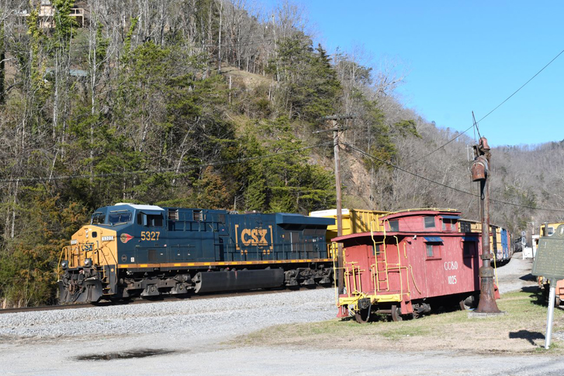 CSX 5327 leads L200-10 past the Elkhorn City Railroad Museum on 03-10-2025. L200 has 23 cars today. Note the Western Maryland decal on the unit.
