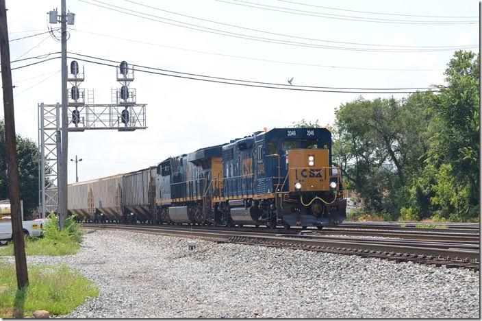 CSX 2046-3159 departs Cumberland MD at Virginia Avenue with V092-28. These are westbound grain empties picked up from the South Branch Valley Railroad at Green Spring WV and heading for Columbus OH. From there the Indiana & Ohio Ry. will take them down the former B&O Midland SD to Cooks OH. No. 2046 is a “GP38-3”. 