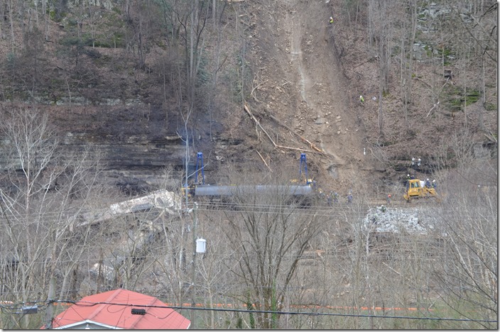 Two Donahue Brothers sidewinders starting to move a tank car. Men scattered up the hill are watching the unstable slide. 02-16-2020. CSX derailment. Draffin KY.