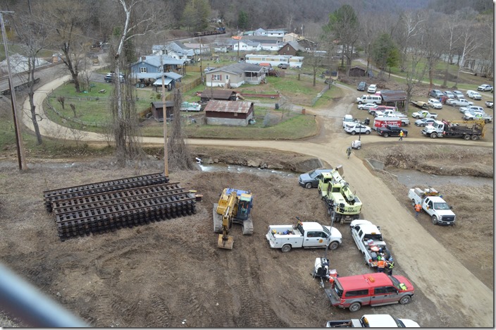 Staging area. Some of the army employed on this derailment. A work train is parked below the crossing. CSX derilment. Draffin KY.