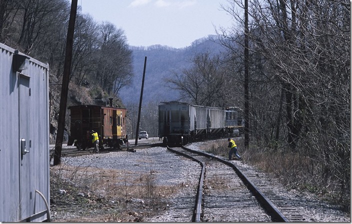 The brakeman resets the derail.