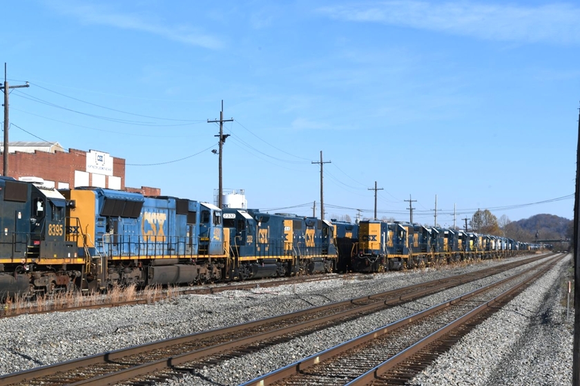 A long line of stored EMD units beside the main line. 11-30-2024. View 2.