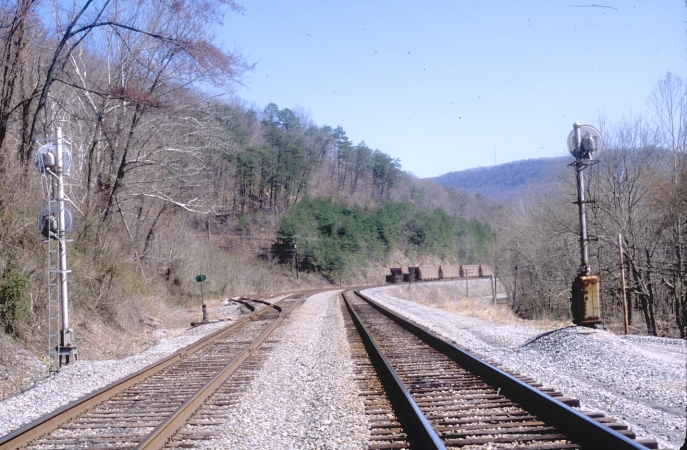 A check of the approach-lit signals at the North End of Pineville revealed nothing.  View is looking south with the passing siding and Wallsend Yard on the left.  A string of ICXX hoppers were stored in the yard. View 1.