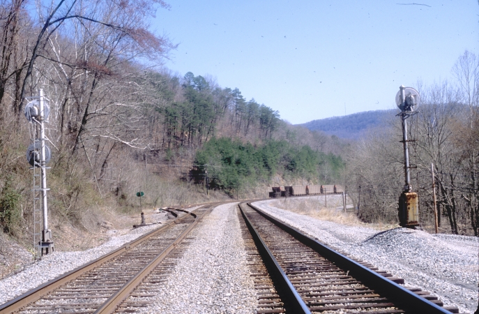 A check of the approach-lit signals at the North End of Pineville revealed nothing.  View is looking south with the passing siding and Wallsend Yard on the left.  A string of ICXX hoppers were stored in the yard. View 1.