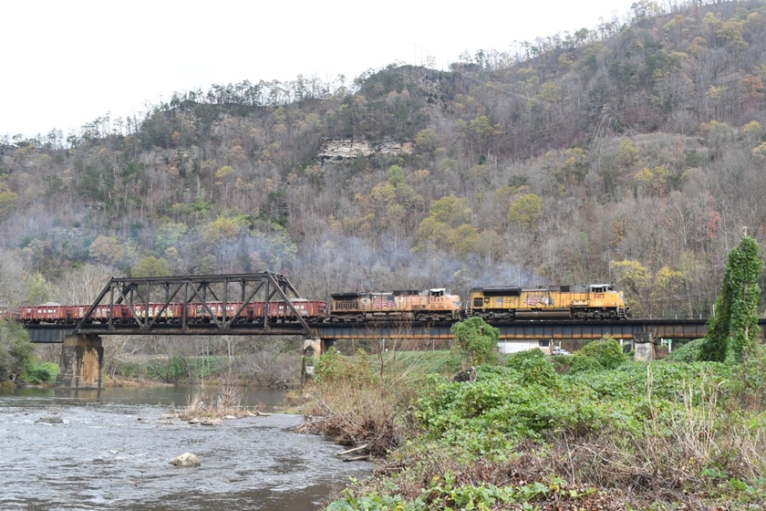 UP 8413-5665 crosses the Russell Fork of the Big Sandy River at Elkhorn City with W092-15. He will hit the steep grade up the former Clinchfield at the end of the bridge. He is on the former C&O here.