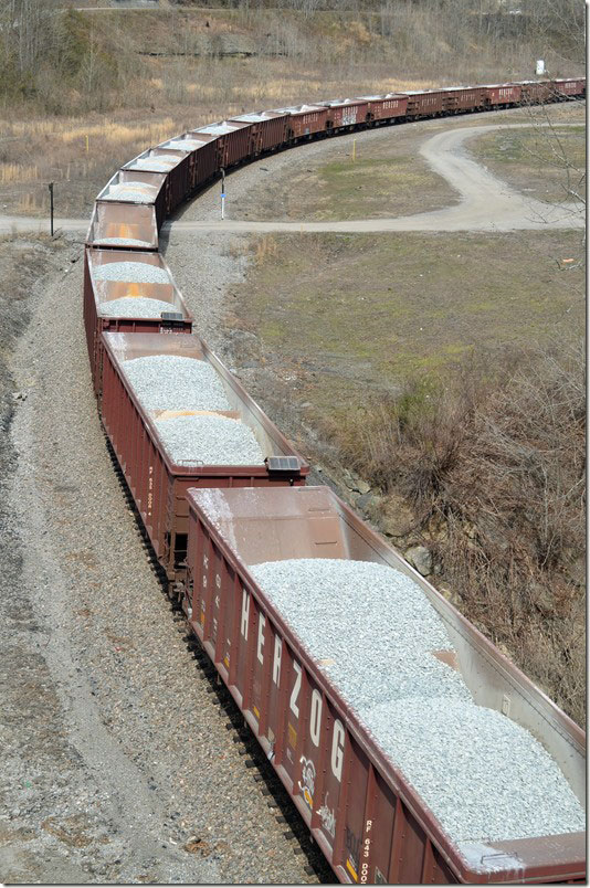 I think it is predetermined where these 60 Herzog Contracting ballast cars will dump automatically. CSX 3303-3230. FO Cabin.