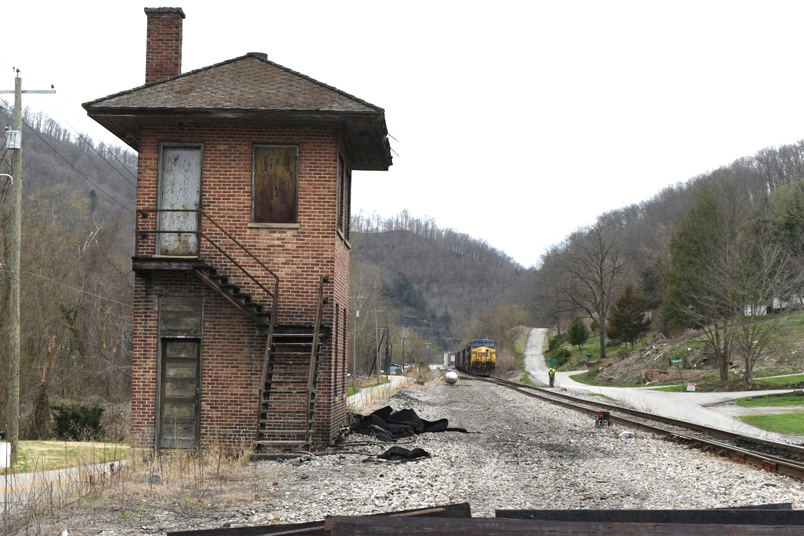 Main track #1 was recently removed from Baxter to Harlan Jct. The conductor aligns the switch to pass the former crossover. In years past Baxter had a leverman to work the switches, as train orders were obtained just up around the curve at Loyall yard office.