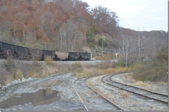 Having found nothing going on at Hazard or Typo mine I decided to retrace my steps toward home. At Deane I met an empty train from Martin coming down the hill off the former C&O E&BV Subdivision. I figured they were going to shove their train up these sidings and load their train at Rapid Load mine. Not so...they only picked up speed and disappeared around the curve. I raced down the curvy state highway trying to overtake the train that was cruising along at 25 m.p.h. The train here is on former C&O track. L&N track was to the right, but it has been removed. CSX 39. Deane KY.