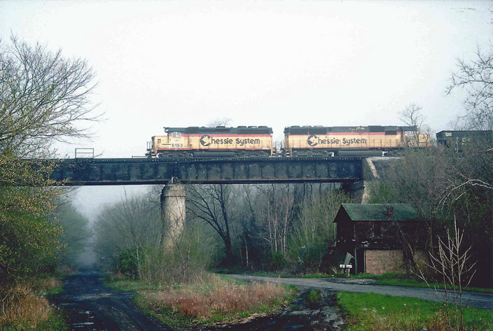 No date. Chessie 6153 in lead. Empty coal drag on the cutoff.